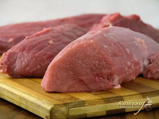 resh beef tenderloin on a wooden board