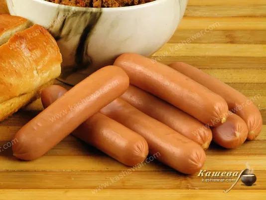 Golden-brown Frankfurter sausages on a wooden board