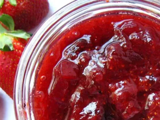 Homemade fruit preserves in a jar with berries