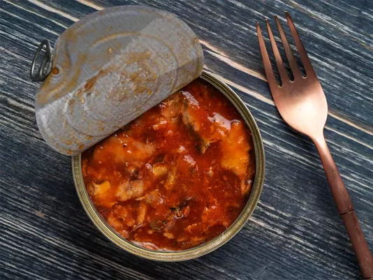 Canned sprat in tomato sauce on a plate