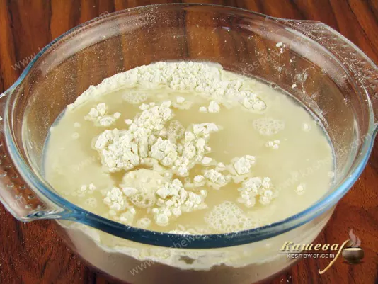 Pour warm water into flour
