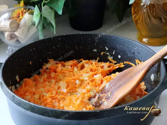 Onions and carrots in a frying pan