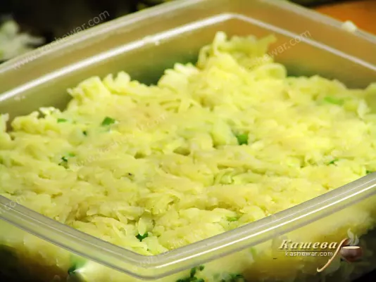 Shredded potatoes over onions