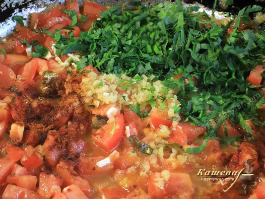 Finely chopped tomatoes, herbs and spices in a frying pan