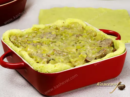Potato dough with vegetables and sausages