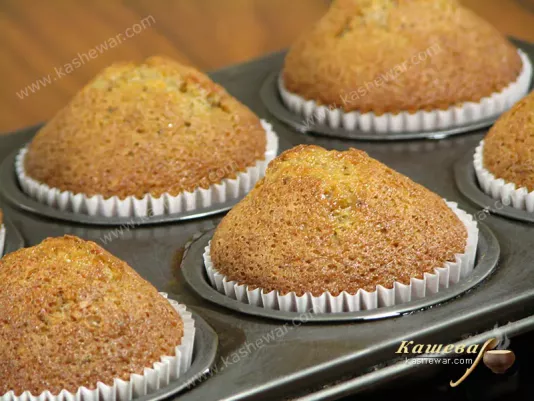 Applying cream to finished cupcakes