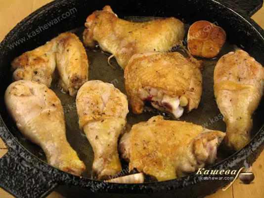 Frying chicken pieces in a pan