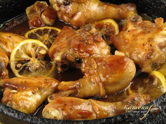 Cooked chicken with lemon in a pan