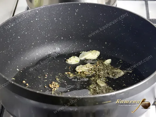 Spices with garlic in a frying pan
