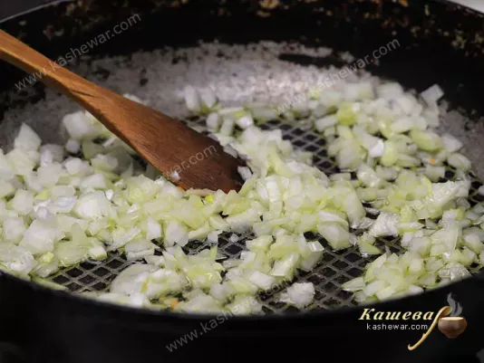Finely chopped onion in a frying pan with olive oil