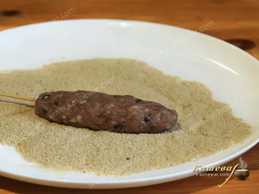 Raw kebab on bread crumbs