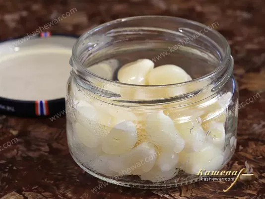 Peeled garlic in a glass jar for canning