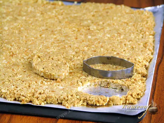 Cutting out a cake base for dessert