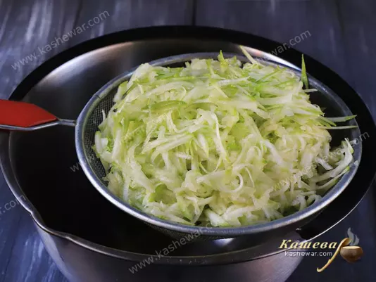 Grated zucchini, in a sieve