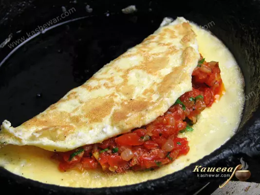 Omelet stuffed with tomatoes