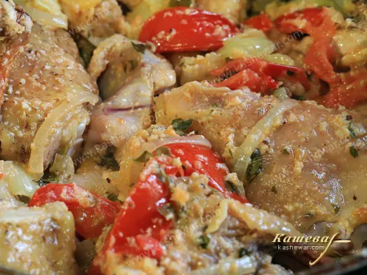 Rooster in a pan with vegetables and spices