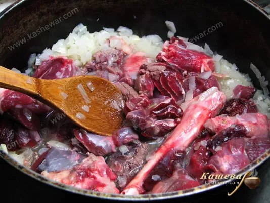 Meat and bones added to fried onions