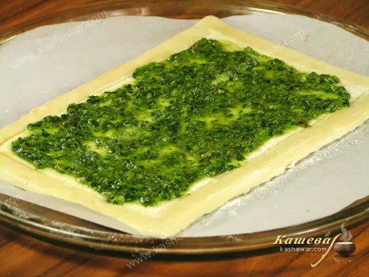 Preparing the pesto pie base