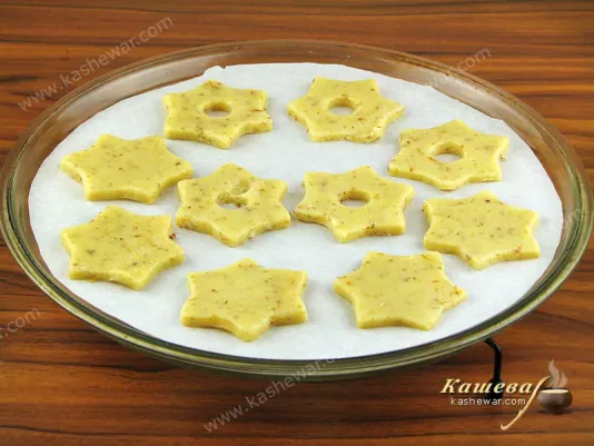 Put the cut out cookies on a paper-covered baking sheet