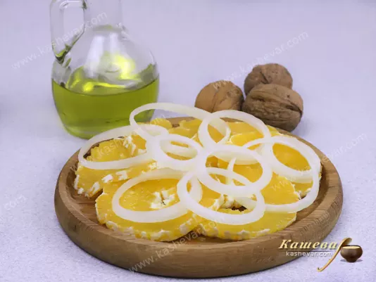 Кольца лука поверх апельсинов