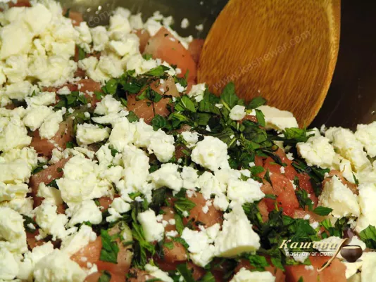 Adding cheese and mint to watermelon salad