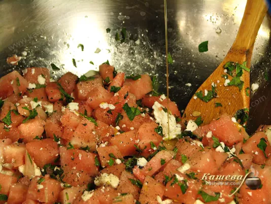 Mixing watermelon salad with cheese
