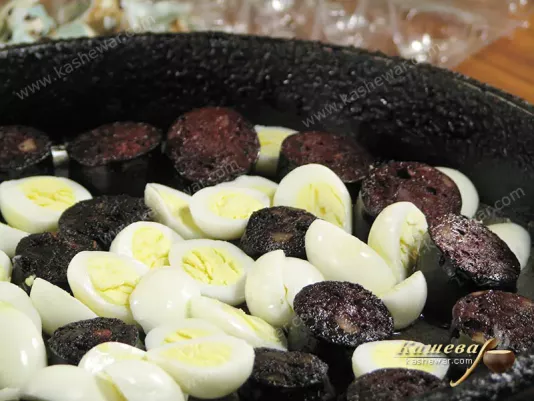 Mixing sausage and eggs for salad