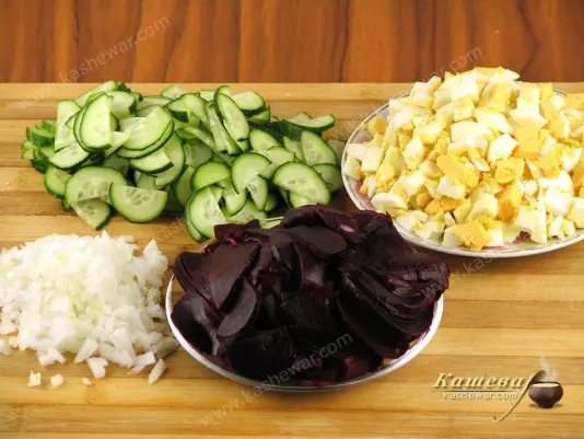 Cutting beets, cucumbers, onions and eggs for salad