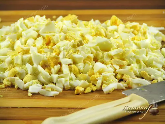 Boil the eggs and then finely chop