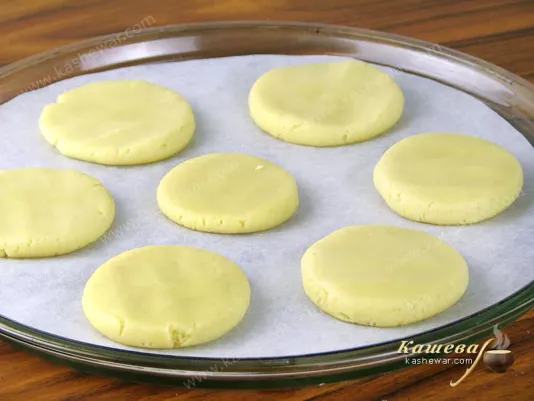 Roll dough into balls and then flatten