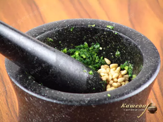 Adding pine nuts to pesto sauce