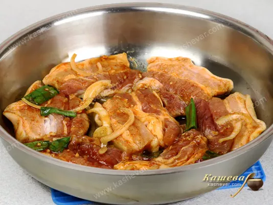 Marinated pork belly in a frying pan
