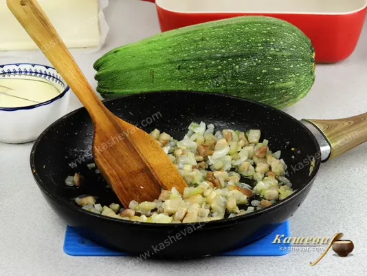 Frying onions and bacon in a pan