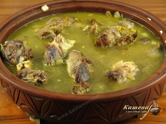 Pour the broth into the tagine