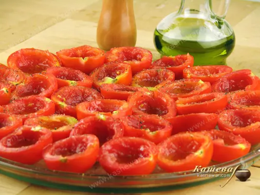 Adding spices and olive oil to sun-dried tomatoes