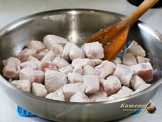 Pork pieces in a frying pan