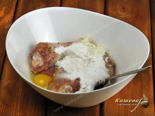 Preparing chicken legs for frying