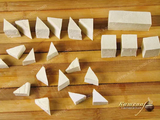 Slicing tofu into triangular pieces